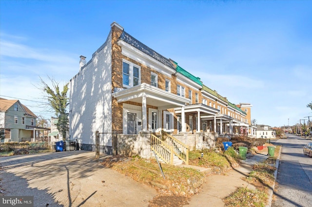 townhome / multi-family property featuring a porch