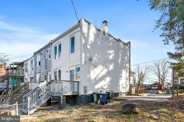 rear view of property featuring central AC