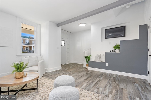 sitting room with beam ceiling and hardwood / wood-style flooring