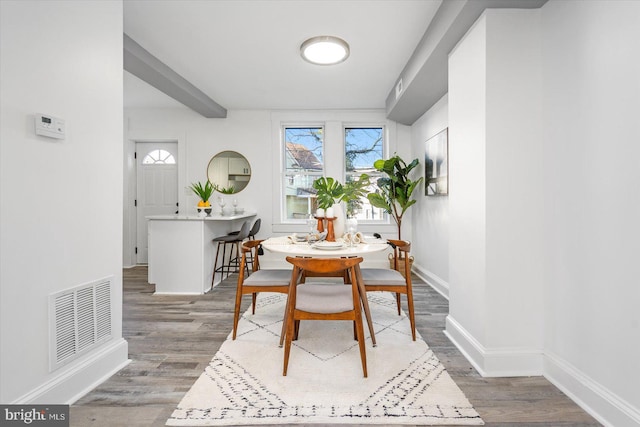 dining space featuring dark hardwood / wood-style flooring