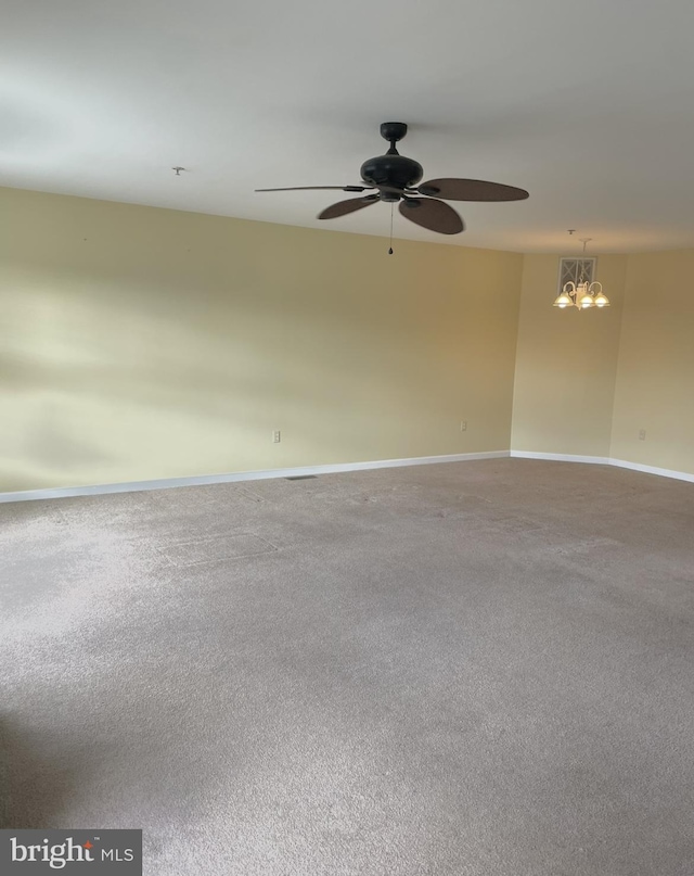 unfurnished room featuring carpet flooring and ceiling fan with notable chandelier