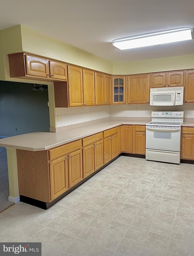 kitchen featuring backsplash and white appliances