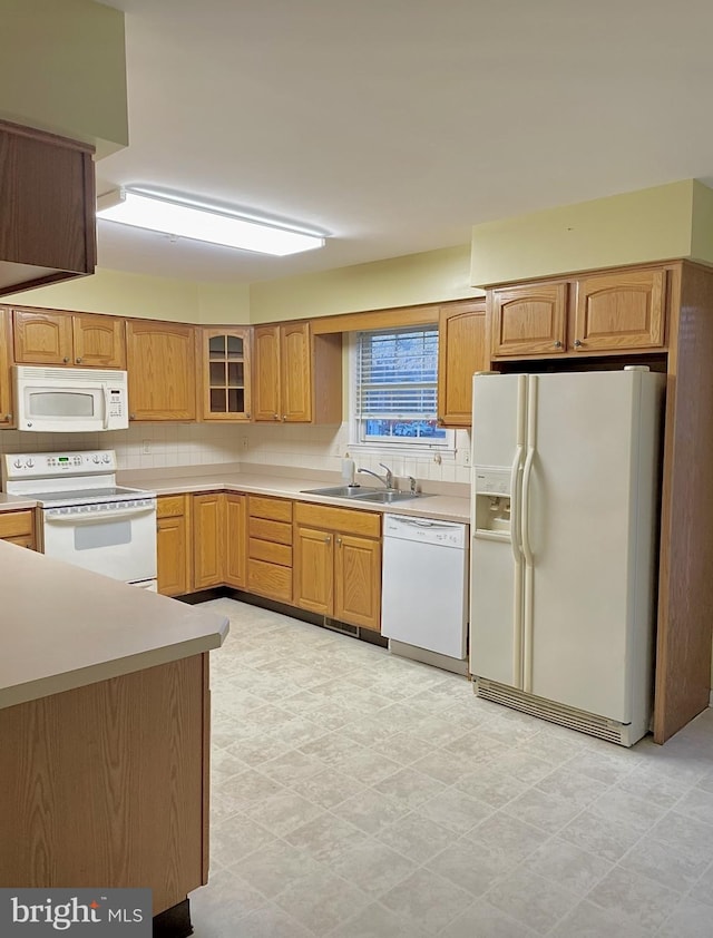 kitchen featuring white appliances and sink