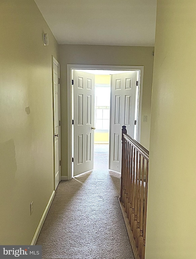 corridor with light colored carpet