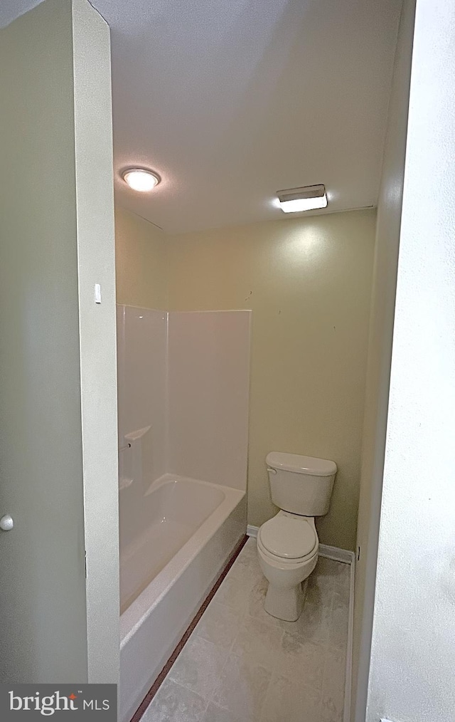 bathroom featuring shower / bathtub combination and toilet