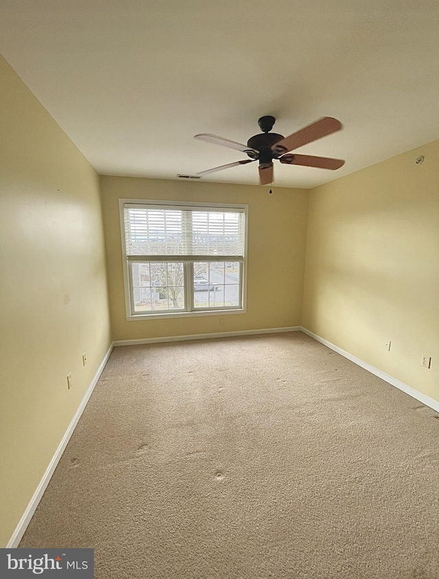 spare room featuring ceiling fan and carpet floors