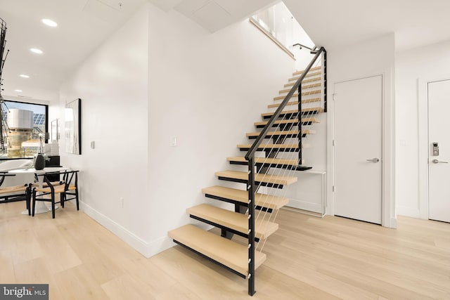 staircase with hardwood / wood-style flooring