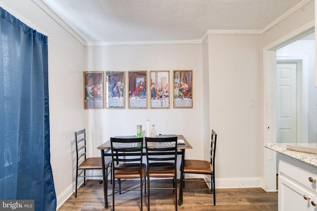 dining area featuring ornamental molding and dark wood-type flooring