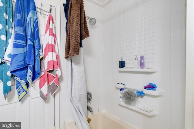 bathroom with shower / bath combo with shower curtain