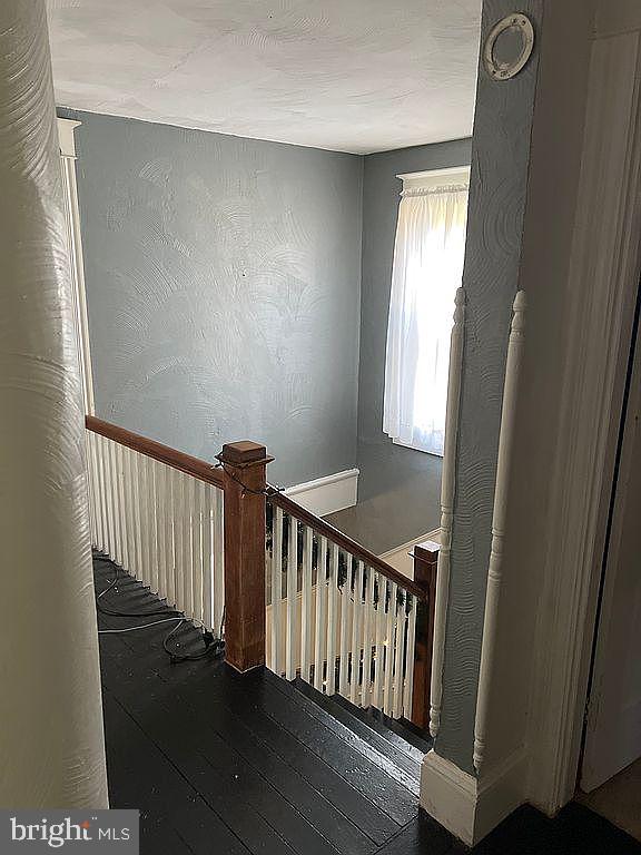 stairway featuring hardwood / wood-style flooring