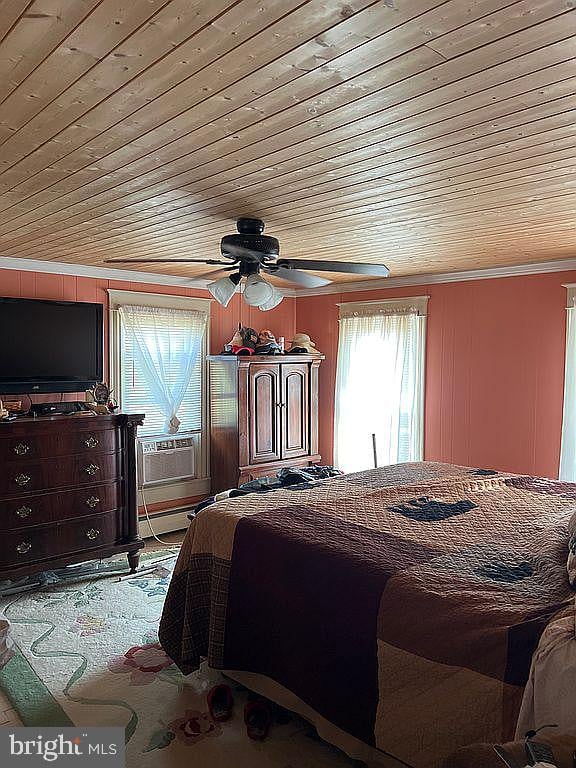 bedroom with ceiling fan, cooling unit, and wood ceiling