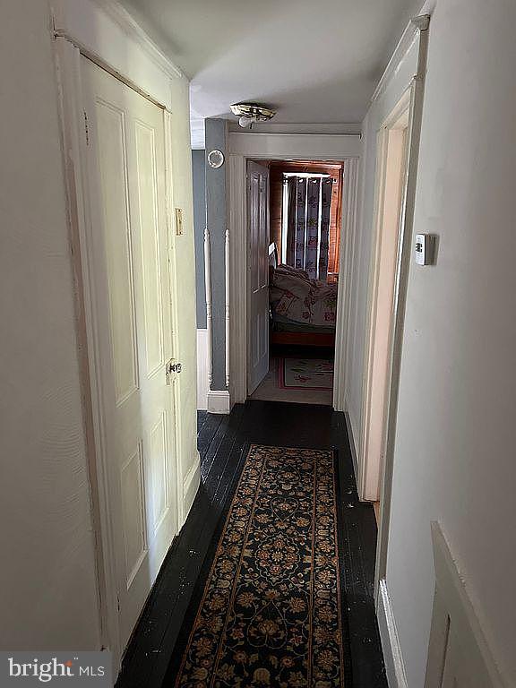 corridor with dark wood-type flooring