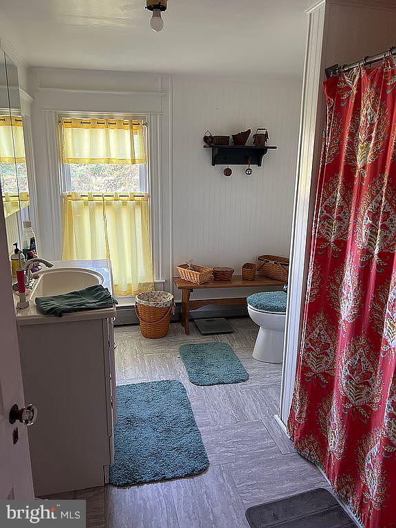 living area featuring sink and a baseboard radiator