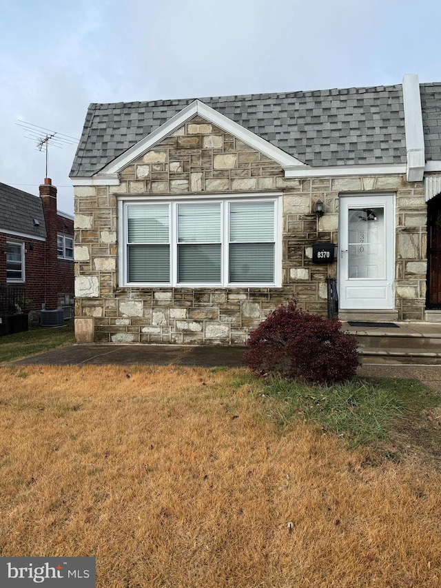 exterior space with a front yard and central air condition unit