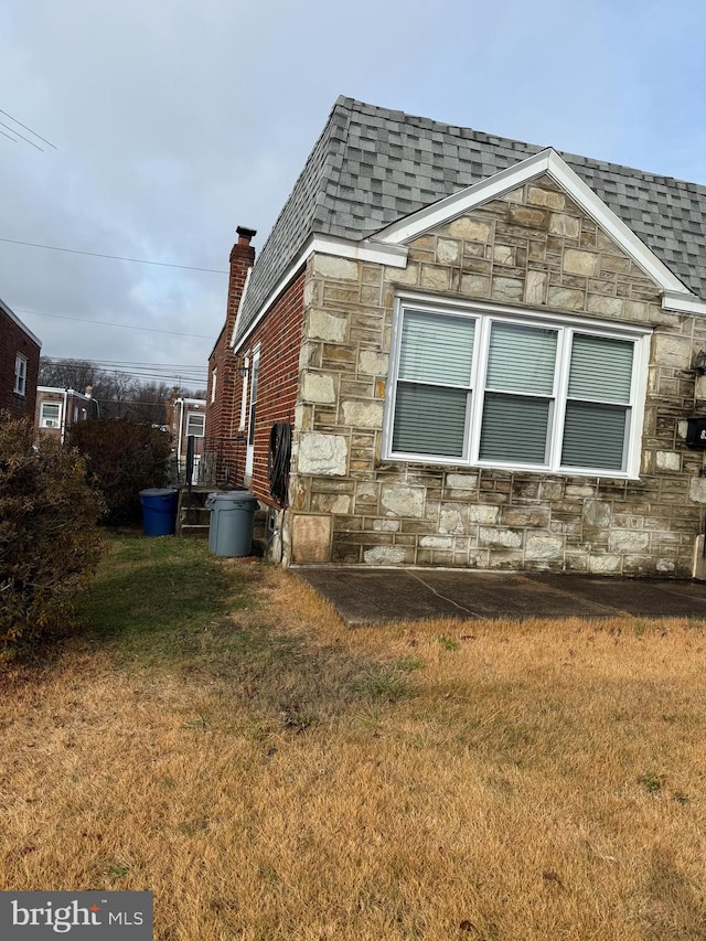 view of home's exterior with a lawn