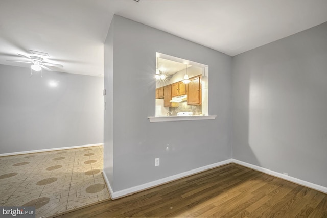 spare room with ceiling fan and hardwood / wood-style flooring