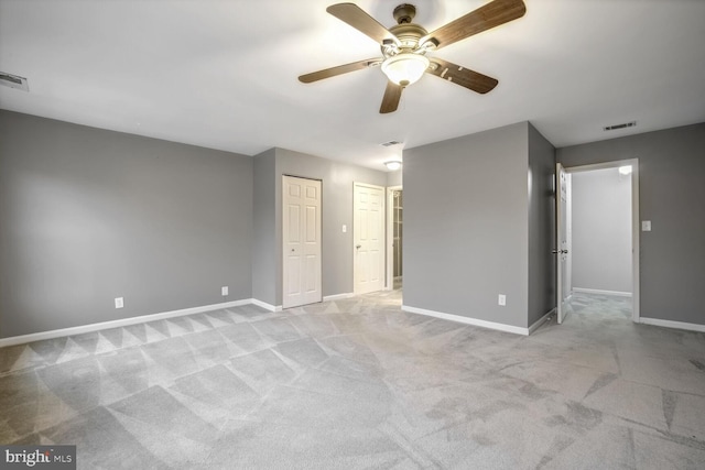 unfurnished bedroom featuring ceiling fan and light carpet