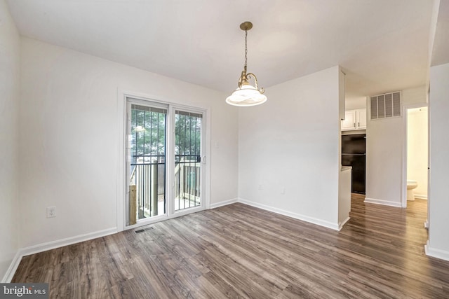 unfurnished room with dark wood-type flooring