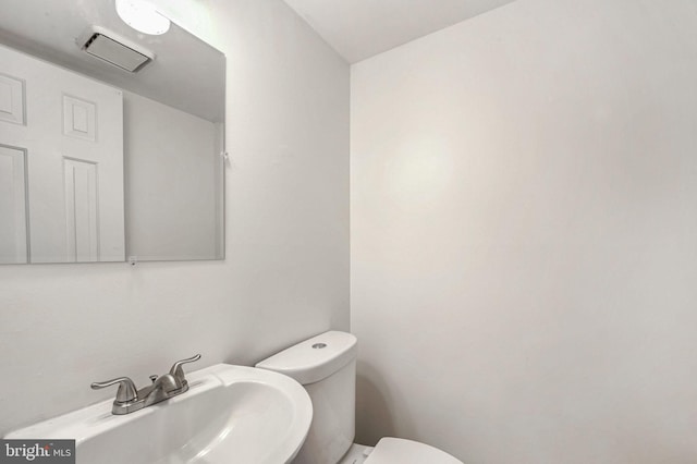 bathroom with toilet and sink