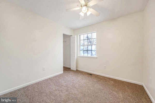 carpeted empty room with ceiling fan