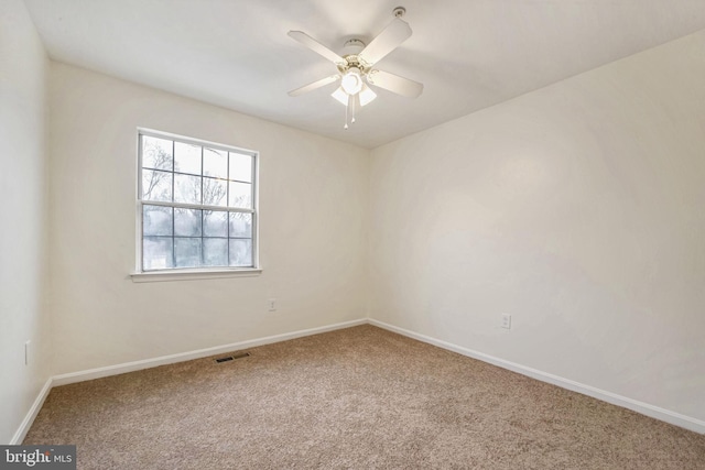 empty room with ceiling fan and carpet floors