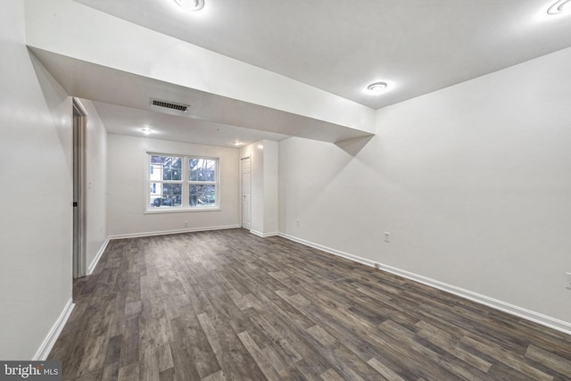 basement with dark hardwood / wood-style flooring