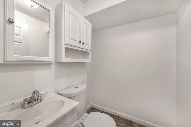 bathroom featuring tile patterned flooring, vanity, and toilet