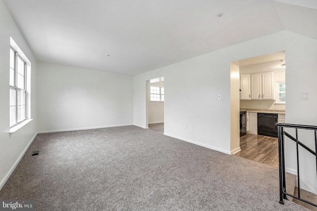 unfurnished living room with light carpet and lofted ceiling