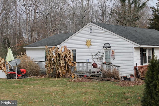 view of front of house with a front yard and a deck