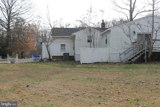 view of home's exterior featuring a lawn and central AC