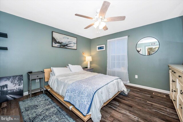 bedroom with dark hardwood / wood-style floors and ceiling fan