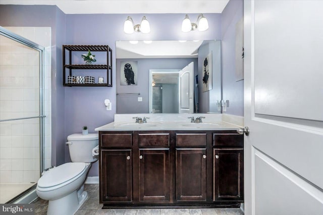 bathroom with vanity, toilet, and a shower with shower door