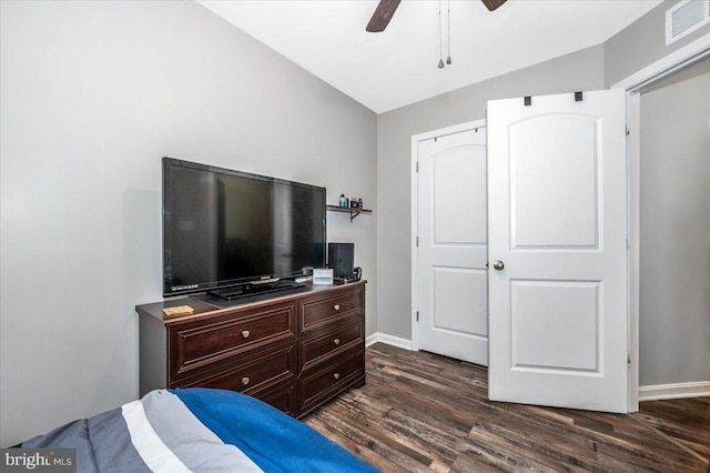 bedroom with ceiling fan, a closet, dark wood-type flooring, and vaulted ceiling