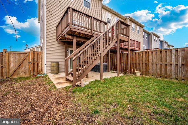 rear view of house featuring a patio, a lawn, cooling unit, and a wooden deck