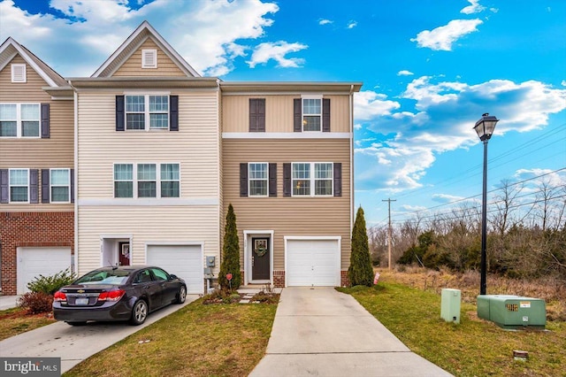 multi unit property with a front yard and a garage