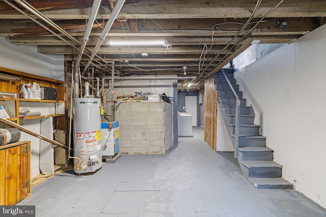 basement with water heater and washer / clothes dryer