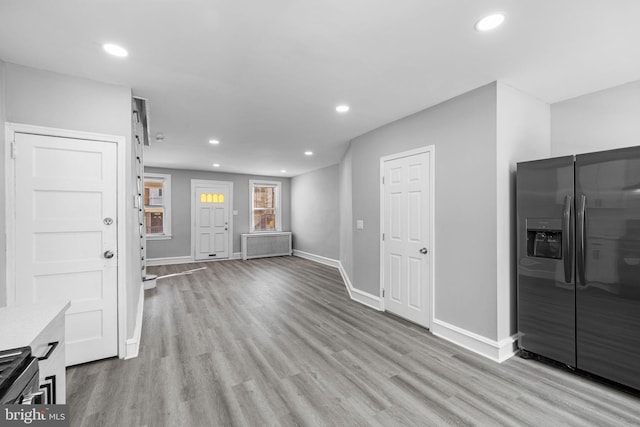 interior space with radiator and light hardwood / wood-style floors