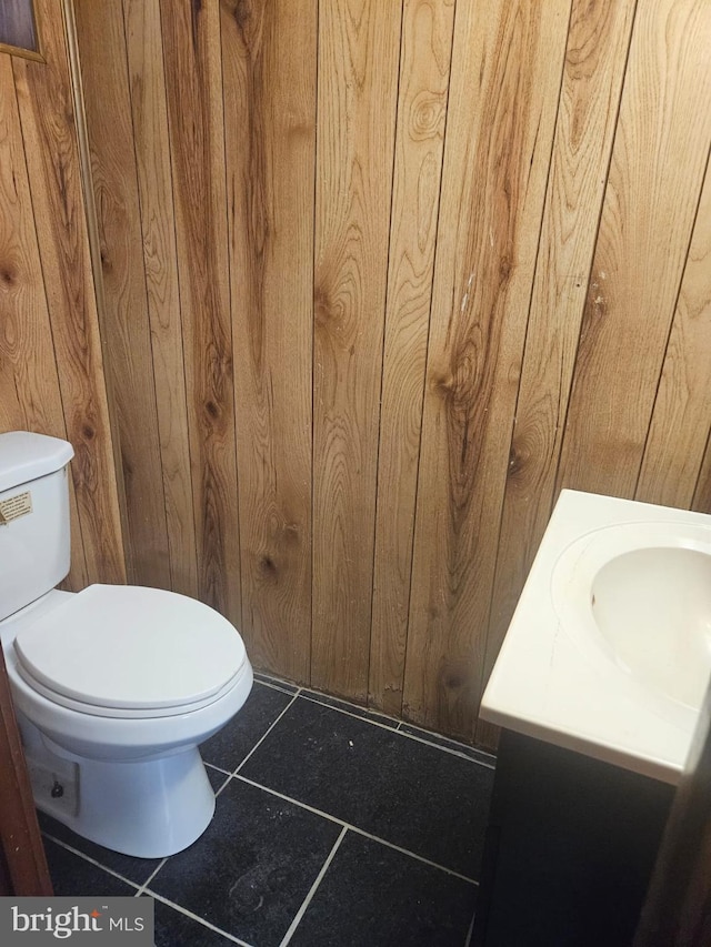 bathroom with tile patterned floors, vanity, and toilet