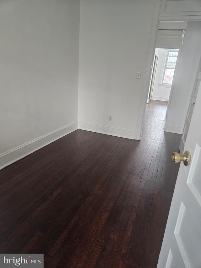 empty room featuring dark wood-type flooring