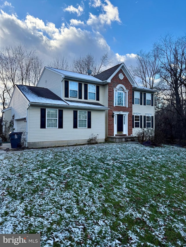 view of front of property featuring a yard and a garage