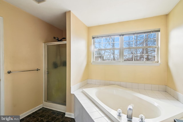 bathroom with plus walk in shower, tile patterned flooring, and a healthy amount of sunlight