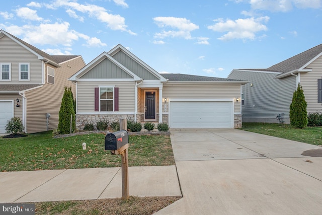 craftsman house featuring a front yard and a garage