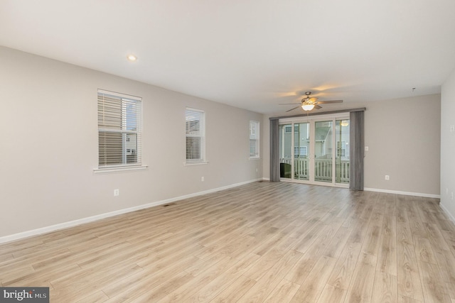 empty room featuring ceiling fan and light wood-type flooring