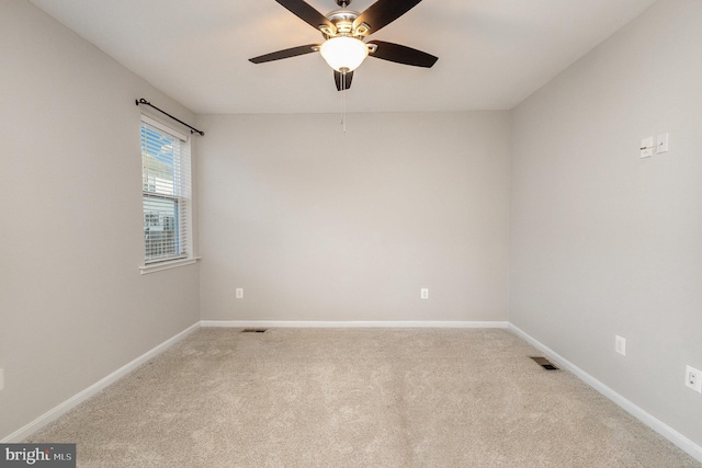 spare room with light carpet and ceiling fan