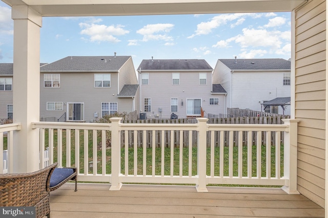 wooden deck featuring a lawn