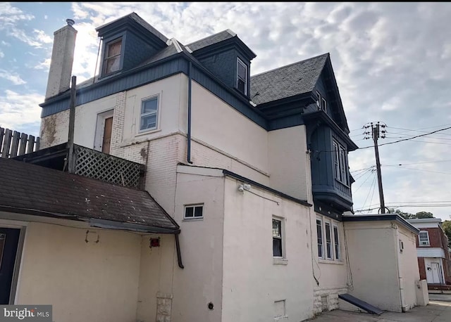 view of side of home with a balcony