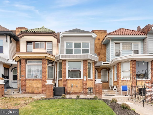 townhome / multi-family property featuring central AC unit and cooling unit