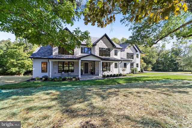 view of front of home featuring a front yard and a porch