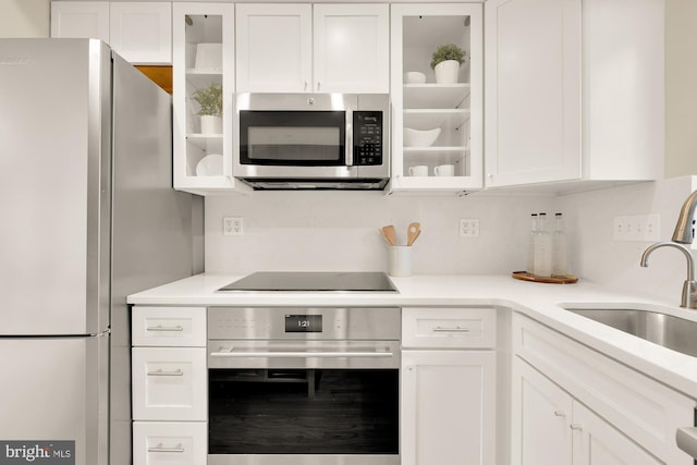 kitchen with white cabinets, sink, and appliances with stainless steel finishes