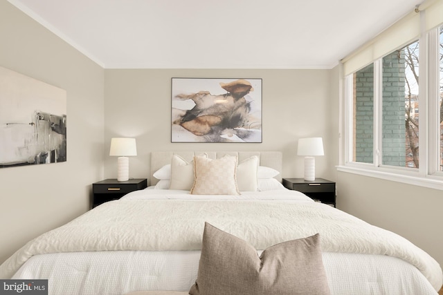 bedroom with crown molding and multiple windows